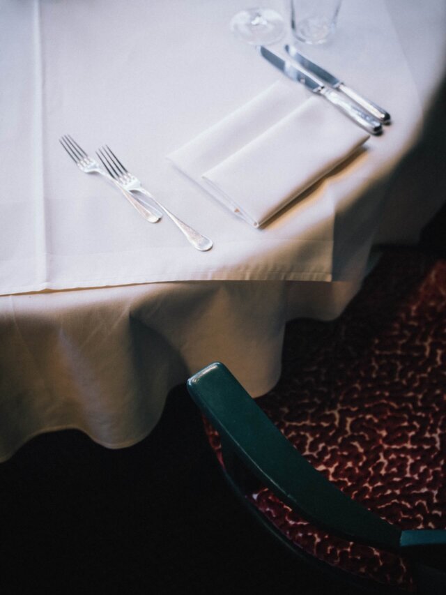 Elegant gedeckter Tisch im Hotel Edelweiss mit Besteck und Tischdecke, perfekte Atmosphäre für genussvolle Mahlzeiten.