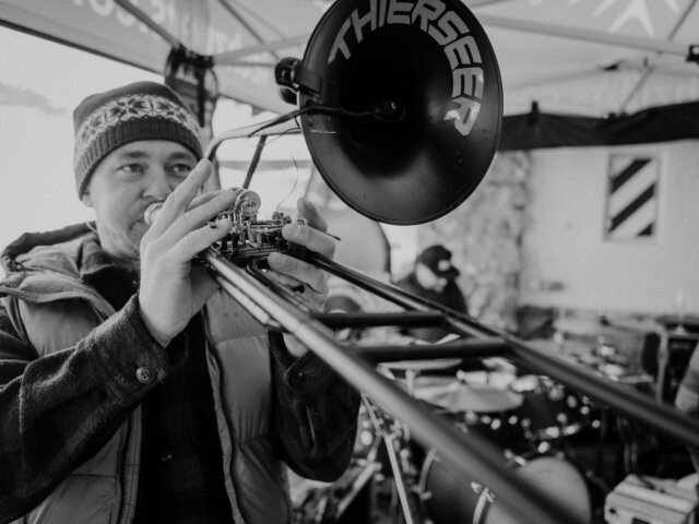 Musiker mit Posaune bei Live-Performance im Hotel Edelweiss in Lech/Zürs am Arlberg während winterlicher Stimmung.