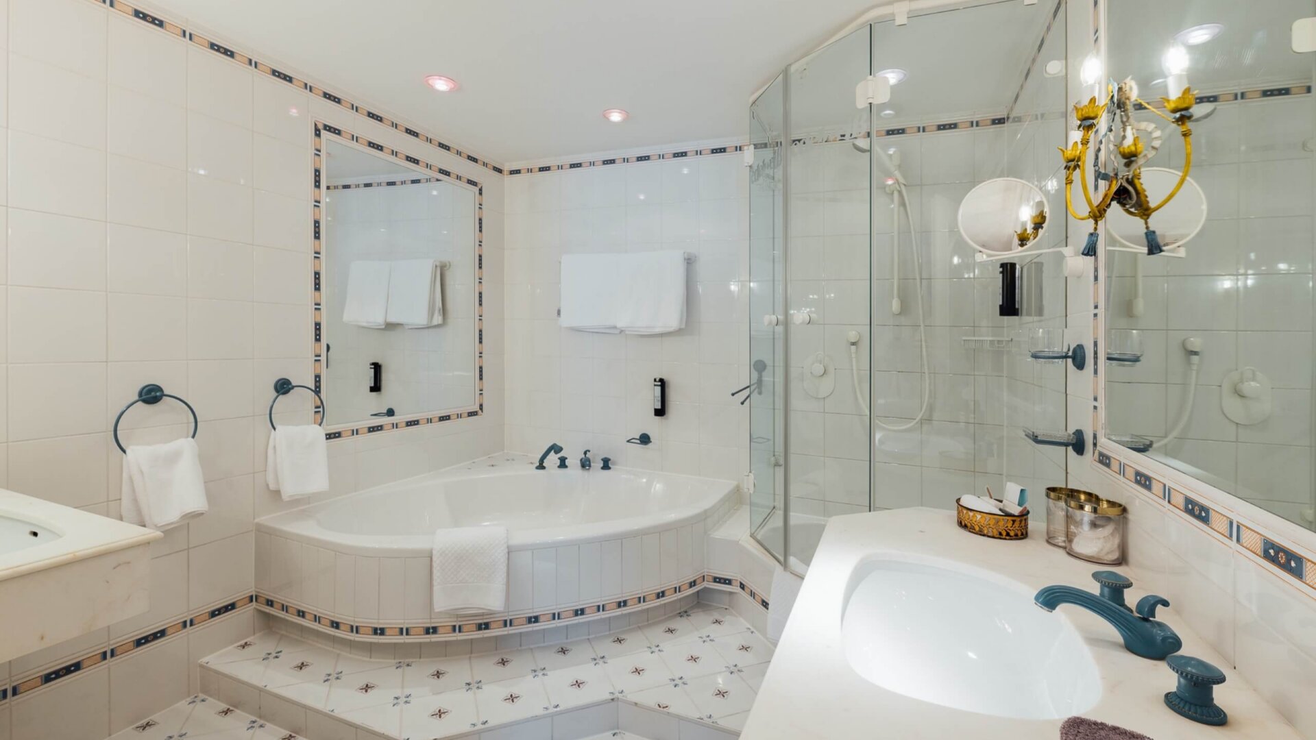 Elegantes Badezimmer im Hotel Edelweiss in Lech/Zürs mit Whirlpool, modernen Armaturen und stilvoller Einrichtung.